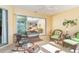 Relaxing lanai with comfortable seating, tropical decor, and access to the living area at 278 Crystal River Dr, Englewood, FL 34223