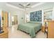Spacious main bedroom with tray ceiling, ensuite, and access to lanai at 278 Crystal River Dr, Englewood, FL 34223
