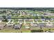 Aerial view of a residential community with houses, lawns, a golf course, and waterfront canals at 279 Mark Twain Ln, Rotonda West, FL 33947