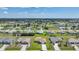 Expansive aerial view of a residential neighborhood, showing multiple houses with manicured lawns and nearby streets at 279 Mark Twain Ln, Rotonda West, FL 33947