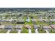 Expansive aerial view of a community with well-maintained homes and green lawns, offering a serene residential setting at 279 Mark Twain Ln, Rotonda West, FL 33947