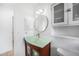 Stylish bathroom with a unique glass sink, wooden cabinet, updated lighting, and cabinet for storage at 279 Mark Twain Ln, Rotonda West, FL 33947