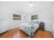 Bright bedroom with a ceiling fan, wood flooring, and 2 windows at 279 Mark Twain Ln, Rotonda West, FL 33947