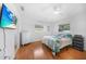 Bright bedroom with a ceiling fan, wood flooring, and a mounted TV at 279 Mark Twain Ln, Rotonda West, FL 33947