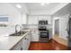 Bright kitchen features stainless steel appliances and white cabinetry for a modern, clean aesthetic at 279 Mark Twain Ln, Rotonda West, FL 33947