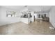 Open layout to the living room, kitchen view, and tile flooring at 279 Mark Twain Ln, Rotonda West, FL 33947