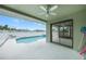 A covered patio overlooks a sparkling pool and backyard, seamlessly blending indoor and outdoor living spaces at 279 Mark Twain Ln, Rotonda West, FL 33947