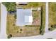 Aerial view of a single-story home with landscaping and neutral color roof at 305 E Wentworth Cir, Englewood, FL 34223