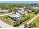 Aerial view of a well-maintained residential neighborhood with lush greenery, a gray roof, and verdant landscaping at 305 E Wentworth Cir, Englewood, FL 34223