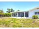 A nice, well maintained backyard with a screened in patio at 305 E Wentworth Cir, Englewood, FL 34223