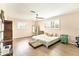 Bright bedroom featuring natural light, wood flooring, and ceiling fan at 305 E Wentworth Cir, Englewood, FL 34223