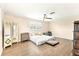 Spacious bedroom featuring wood flooring, natural light, and a ceiling fan at 305 E Wentworth Cir, Englewood, FL 34223