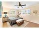Comfortable bedroom featuring wood flooring, natural light, and a ceiling fan at 305 E Wentworth Cir, Englewood, FL 34223