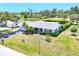 Well-maintained single-story home boasts tidy landscaping and a spacious front yard, complemented by vibrant green grass at 305 E Wentworth Cir, Englewood, FL 34223