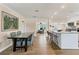 Dining area transitions into kitchen with island and bar seating plus stainless steel appliances at 305 E Wentworth Cir, Englewood, FL 34223