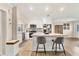 Kitchen with granite countertops, stainless steel appliances, and barstool seating at the island at 305 E Wentworth Cir, Englewood, FL 34223