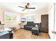 Cozy living room with wood flooring, natural light, and comfortable seating at 305 E Wentworth Cir, Englewood, FL 34223