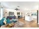 Open floor plan showcasing wood floors, an island kitchen, a dining area, and comfortable seating at 305 E Wentworth Cir, Englewood, FL 34223