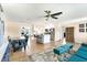Bright, open floor plan featuring wood floors, a kitchen island, and neutral decor at 305 E Wentworth Cir, Englewood, FL 34223