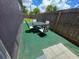 This image shows a patio table and chairs within a fenced backyard at 3157 Crestwood Dr, Port Charlotte, FL 33952