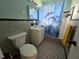 Cozy bathroom with a dolphin-themed shower curtain, mosaic floors, and a sink vanity at 3157 Crestwood Dr, Port Charlotte, FL 33952
