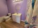 Bathroom featuring a toilet, vanity, and a shower with a colorful curtain at 3157 Crestwood Dr, Port Charlotte, FL 33952