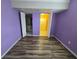 Bedroom with vinyl flooring, closet doors, and purple walls at 3157 Crestwood Dr, Port Charlotte, FL 33952