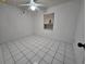 Cozy bedroom with tile flooring, a ceiling fan, a bright window, and ready for personalization at 3157 Crestwood Dr, Port Charlotte, FL 33952