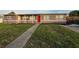 Charming single-story home with a red front door and a walkway leading to the entrance at 3157 Crestwood Dr, Port Charlotte, FL 33952