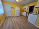Bright kitchen with vinyl flooring, white appliances, and yellow walls at 3157 Crestwood Dr, Port Charlotte, FL 33952