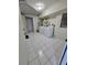 Bright laundry room with white tile flooring, washer, and dryer at 3157 Crestwood Dr, Port Charlotte, FL 33952