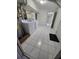 Bright laundry room with white tile flooring, washer, and dryer at 3157 Crestwood Dr, Port Charlotte, FL 33952