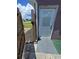 This image shows a side entrance and a partial view of a neighboring residence at 3157 Crestwood Dr, Port Charlotte, FL 33952