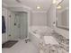 Bright bathroom with a glass enclosed shower, soaking tub, granite vanity, and large mirror at 3695 Waffle Ter, North Port, FL 34286