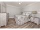 Comfortable bedroom featuring wood-look floors, ceiling fan, and a coordinated neutral color scheme at 3695 Waffle Ter, North Port, FL 34286