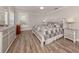 Comfortable bedroom featuring wood-look floors, ceiling fan, and a coordinated neutral color scheme at 3695 Waffle Ter, North Port, FL 34286