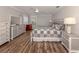 Comfortable bedroom featuring wood-look floors, ceiling fan, and a coordinated neutral color scheme at 3695 Waffle Ter, North Port, FL 34286