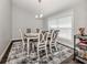 Elegant dining room with a six-chair table and a patterned rug at 3695 Waffle Ter, North Port, FL 34286