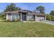 Charming single-story home featuring a well-manicured lawn, screened entry, and a two-car garage at 3695 Waffle Ter, North Port, FL 34286