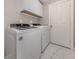 Neat laundry room equipped with modern white appliances and ample storage space at 3695 Waffle Ter, North Port, FL 34286