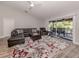 Spacious living room with access to a screened-in patio, and featuring stylish furniture at 3695 Waffle Ter, North Port, FL 34286