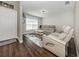 Bright living room features a modern sofa, stylish rug, and hardwood floors at 3695 Waffle Ter, North Port, FL 34286