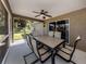 Relaxing screened patio with ceiling fan, dining table set, and view of backyard at 3695 Waffle Ter, North Port, FL 34286