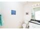 Neutral-toned half bathroom featuring a vanity and modern lighting fixtures and hardware at 3929 Cape Haze Dr # 101, Rotonda West, FL 33947