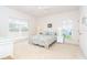 This bedroom has two windows and light colored carpet and furnishings at 3929 Cape Haze Dr # 101, Rotonda West, FL 33947
