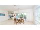 Dining area with a glass table, stylish seating, and sliding doors to the outside at 3929 Cape Haze Dr # 101, Rotonda West, FL 33947