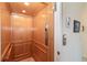Private residential elevator featuring wood paneled walls and chrome buttons for easy access at 3929 Cape Haze Dr # 101, Rotonda West, FL 33947