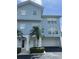 Charming blue townhome exterior featuring a private garage and well-manicured landscaping at 3929 Cape Haze Dr # 101, Rotonda West, FL 33947
