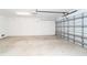 Spacious garage with ample room for parking and storage, featuring an automatic door and lighting at 3929 Cape Haze Dr # 101, Rotonda West, FL 33947