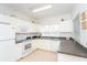 Bright kitchen with white cabinets, modern appliances, and dark countertops at 3929 Cape Haze Dr # 101, Rotonda West, FL 33947